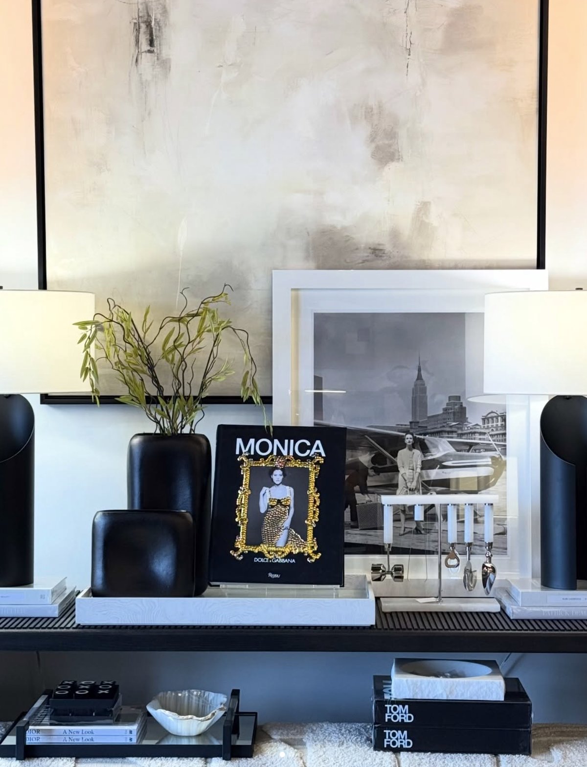 Styled console in the Busted 2 Bangin shop — coffee table books, lamps and objects